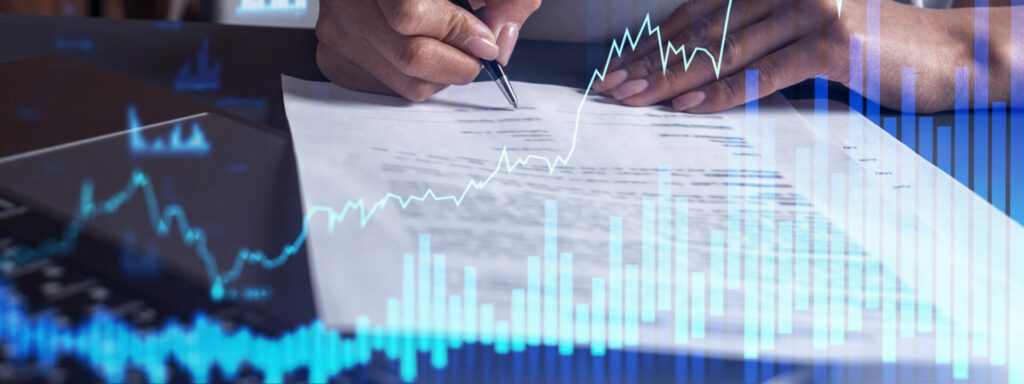 A stock chart overlaying a photo of a person signing a document.