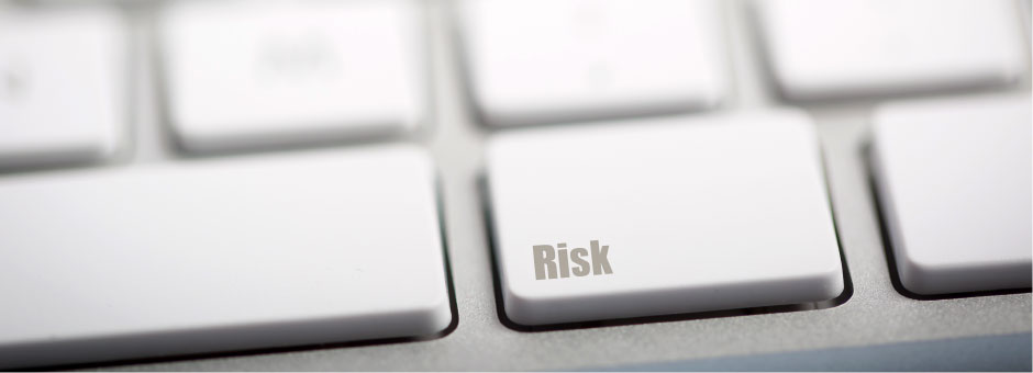 Close-up of a keyboard focused on key that says Risk